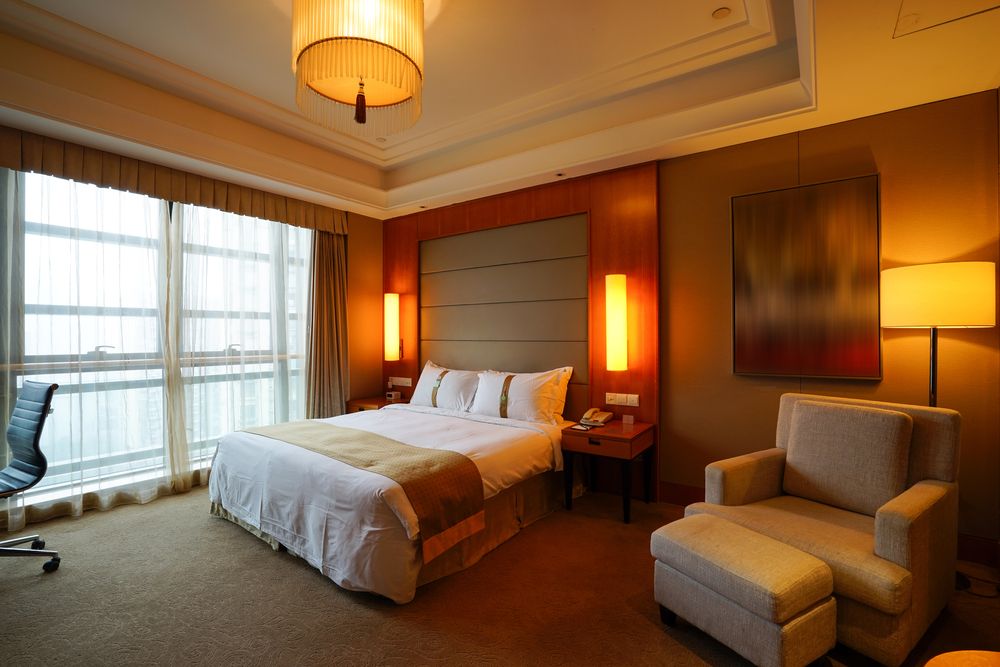 A cozy guest bedroom with inviting decor, featuring a comfortable bed, soft lighting, and welcoming ambiance.