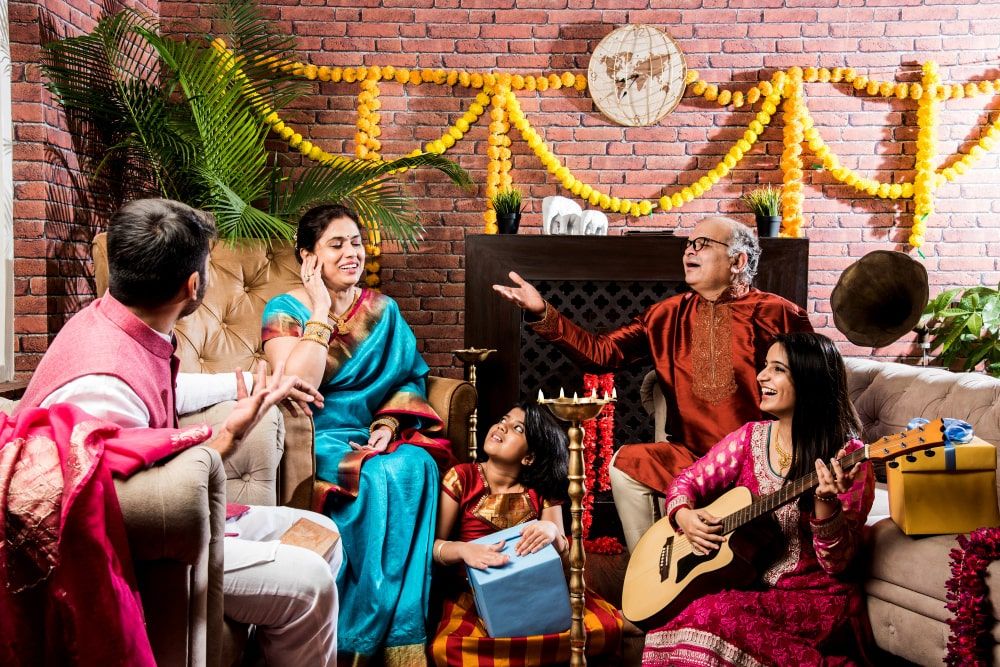 happy-indian-family-singing-playing-music-guitar-while-celebrating-festivals-traditional-cloths-min.jpg