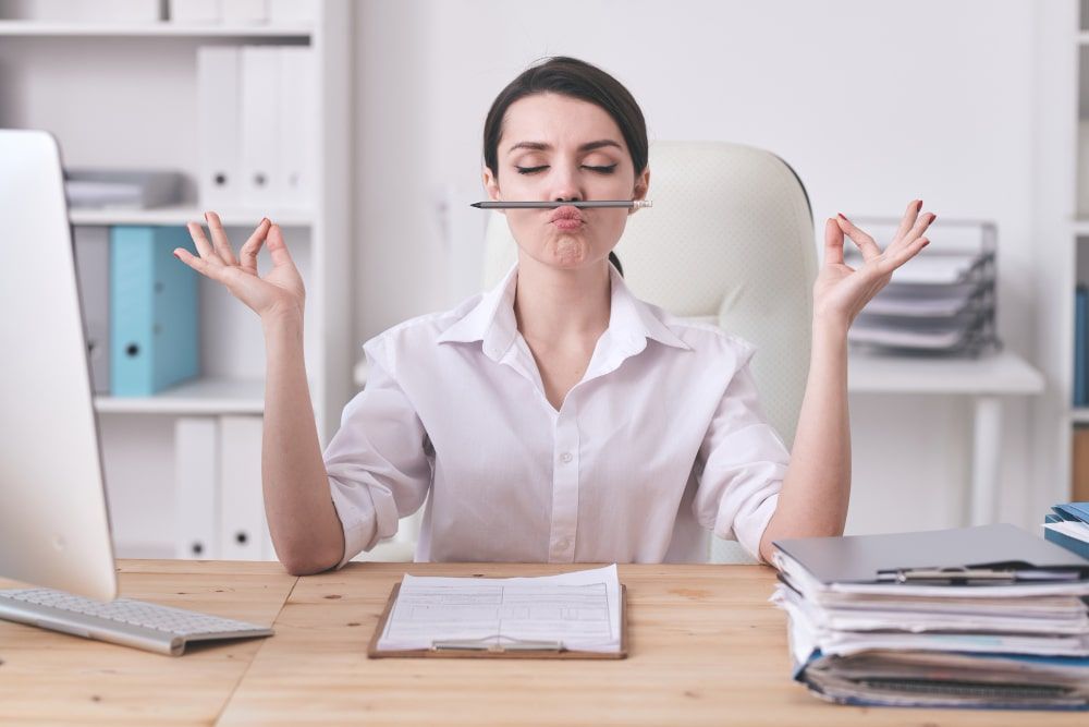 young-female-office-manager-secretary-with-pencil-her-nose-mouth-trying-relax-after-hard-working-day-by-workplace-min.jpg